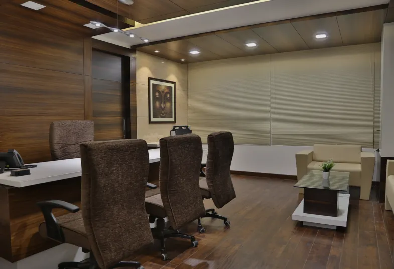 Executive office with a desk, meeting chairs and a sofa